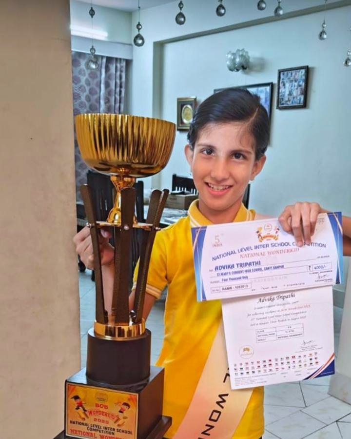 Student with National Wonderkid trophy, sash and certificate