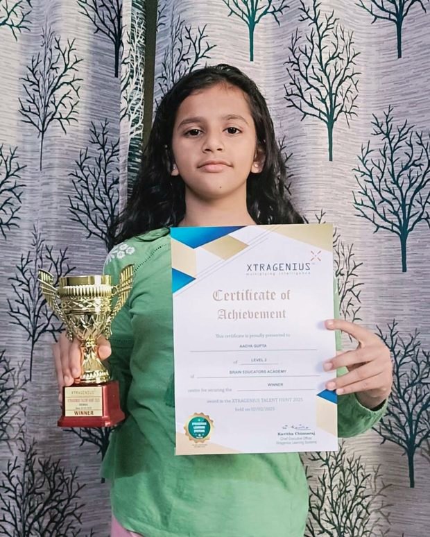 Student with winner certificate and trophy